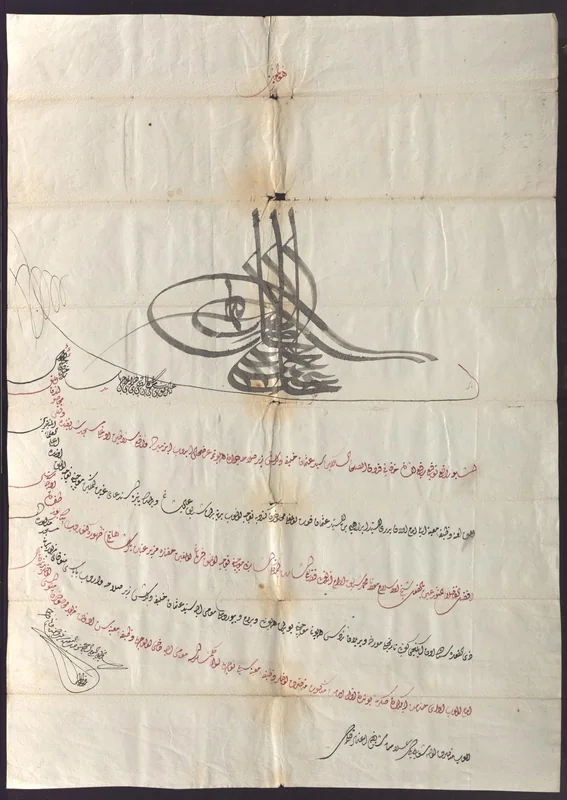 An Ottoman decree with seven sloping lines in red and black Diwani below a large tughra.