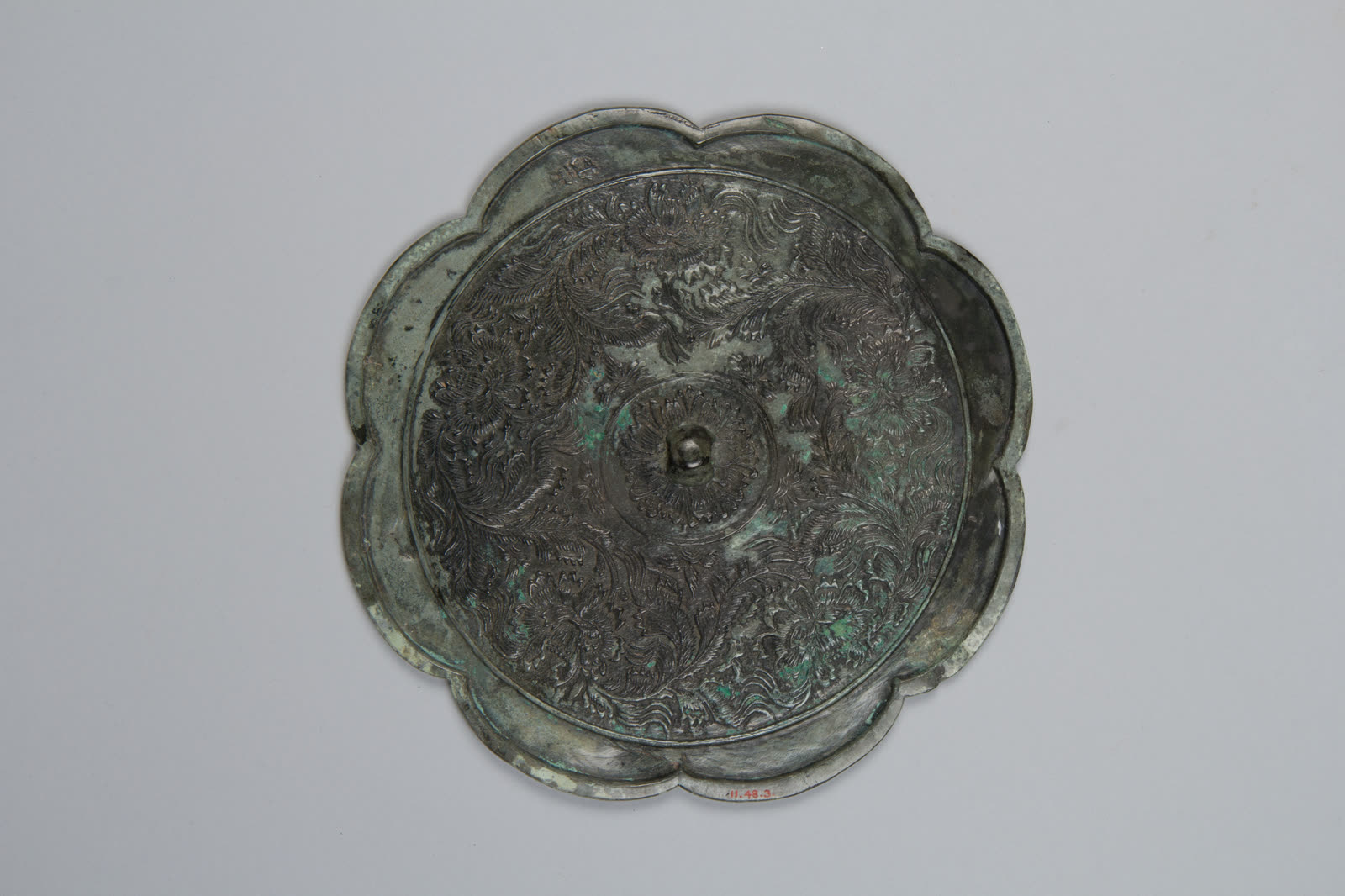 Mirror decorated with palmette and arabesque motifs